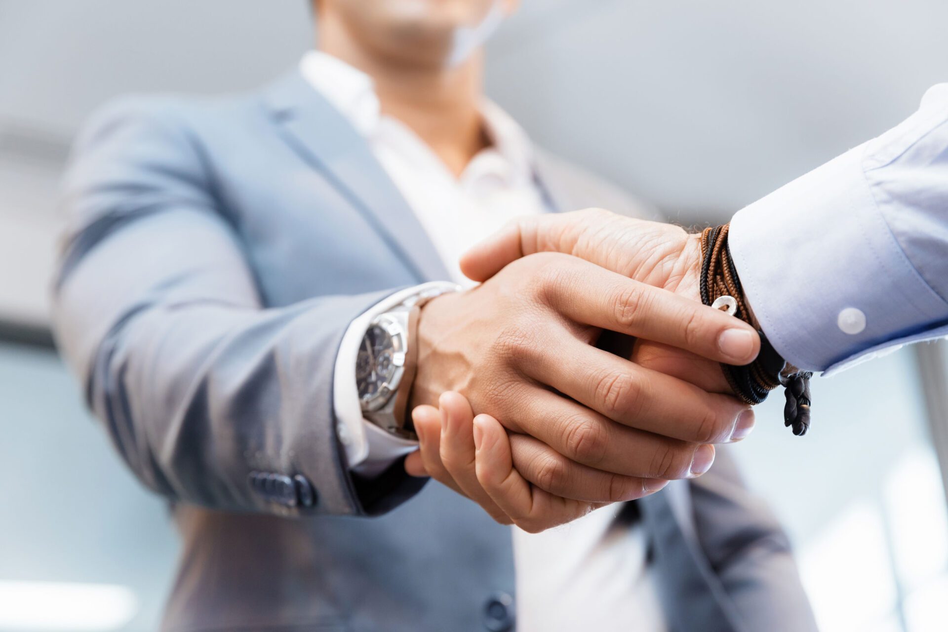 Handshake of businessmenoncepts - soft focus Red Toyota Prius driving through trees